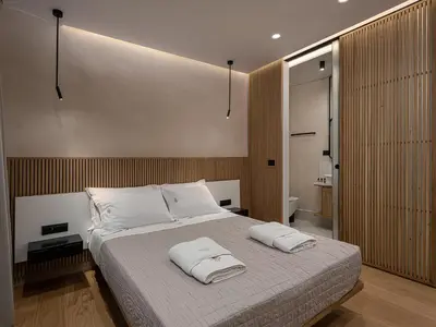 a bedroom with a large bed with two towels on it at Aoria Estate Old Port in Chania Town
