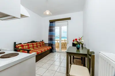a living room with a couch and a table at Asterina Seaside Apartments in Kalyves