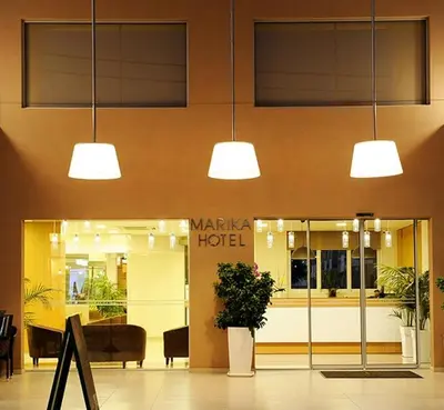 a lobby of a hotel with three lights at Marika Beach Hotel in Plataniás