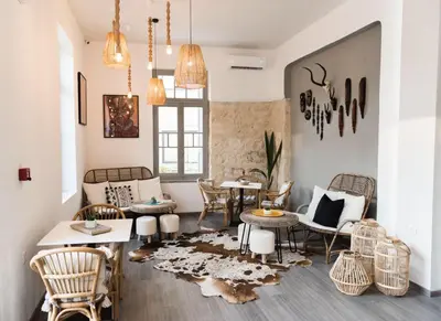 a living room with a table and chairs at Kumba in Chania Town