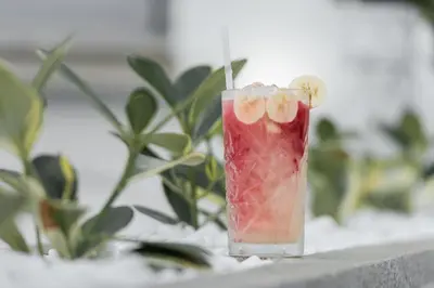 a drink sitting on a ledge next to a plant at Kumba in Chania Town