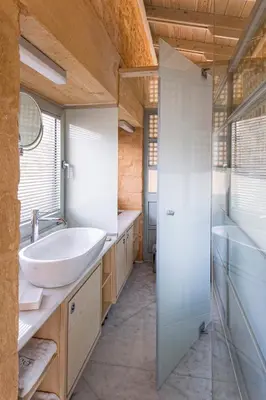 a bathroom with a sink and a glass shower at Olea Villas - Infinity Pool, Hot Tub, Sea Views in Marathi