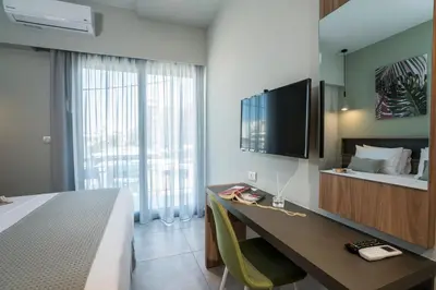 a hotel room with a desk and a large window at Mediterranean Luxury Apartment in Chania Town