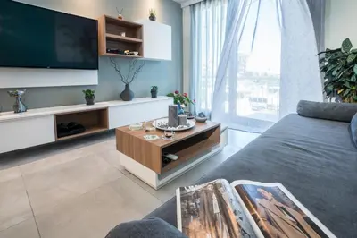 a living room with a tv and a couch at Mediterranean Luxury Apartment in Chania Town