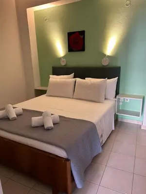 a bedroom with a large bed with two towels on it at Fougaro Apartments in Chania Town