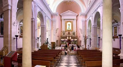 a woman sitting in a church with pews at Fougaro Apartments in Chania Town