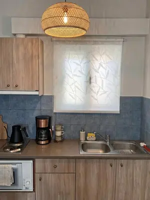 a kitchen with a sink and a microwave at Marianna Apartments in Almirida