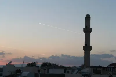 a tall obelisk in a city at sunset at Agapi Suites in Chania Town