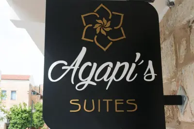 a sign for a hotel with a sign for a suite at Agapi Suites in Chania Town