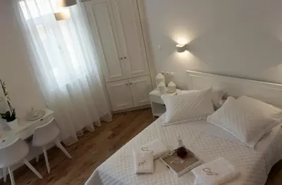 a bedroom with a white bed with a tray on it at Agapi Suites in Chania Town