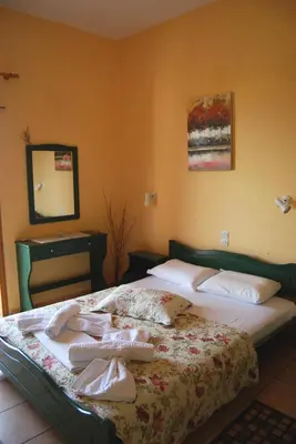 a bedroom with a bed with towels on it at Golden Sun Apartments in Falasarna