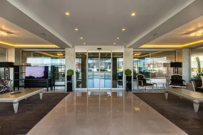 a lobby with tables and chairs in a building at Oniros Residences in Souda