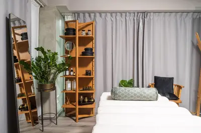 a bedroom with a white bed and a book shelf at Oniros Residences in Souda