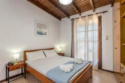 a bedroom with a bed with two towels on it at Diktamo House in Agia Marina Nea Kydonias
