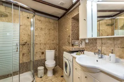 a bathroom with a toilet and a sink and a shower at Diktamo House in Agia Marina Nea Kydonias