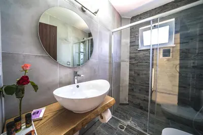 a bathroom with a sink and a mirror at Petronila Luxury Villa with heated private pool in Kissamos