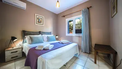 a bedroom with a bed with towels on it at Petronila Luxury Villa with heated private pool in Kissamos