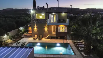a house with a swimming pool in front of it at Petronila Luxury Villa with heated private pool in Kissamos