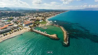 an aerial view of a beach and the ocean at 2-Bedroom Blue & White House with Garden and Beach in Plataniás