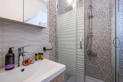 a bathroom with a sink and a shower at Vereniki Suites Chania in Chania Town