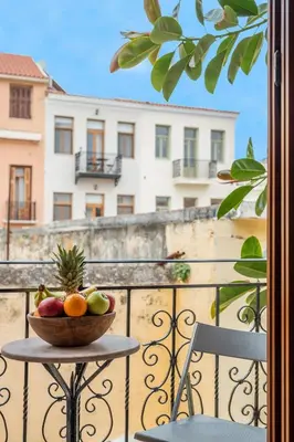 a bowl of fruit on a table on a balcony at Vereniki Suites Chania in Chania Town