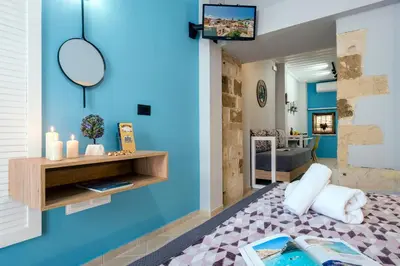 a living room with a blue wall at Vereniki Suites Chania in Chania Town