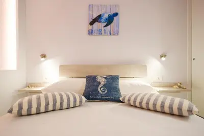 a bedroom with a white bed with two pillows at Gina's home in Kolymvari