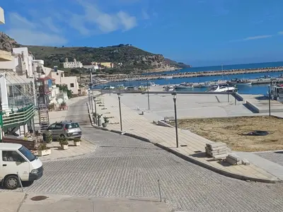 a street with cars parked next to the ocean at Gina's home in Kolymvari