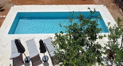 an overhead view of a swimming pool with chairs and a plant at PALACE Mountain view in Megála Khoráfia