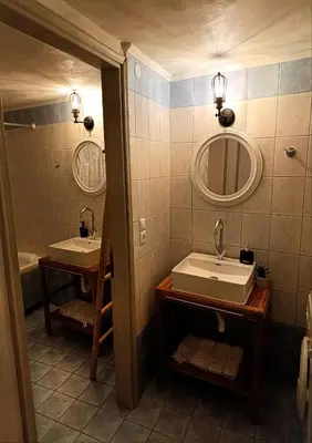 a bathroom with two sinks and a mirror at PALACE Mountain view in Megála Khoráfia