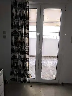 an empty room with a door and a window at Zamboli in Chania Town