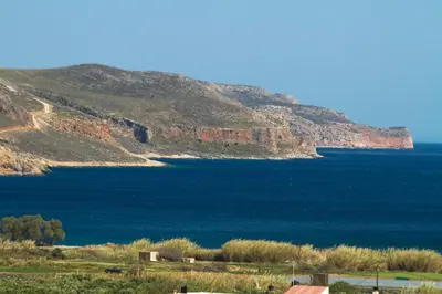 a large body of water with a mountain in the background at Georgia Sunset in Trákhilos