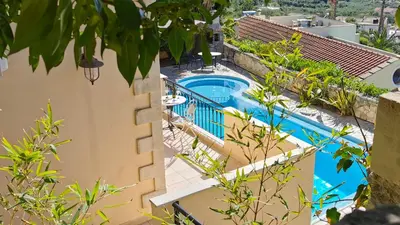 a view of a pool from a house at Villa Koumos - Crete Holidays With Pool and Views in Gavalochori