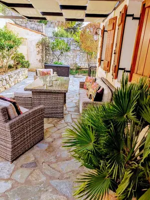 a patio with a table and chairs and plants at Villa Koumos - Crete Holidays With Pool and Views in Gavalochori