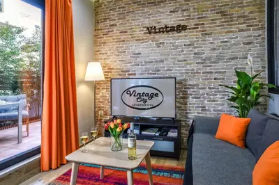 a living room with a couch and a brick wall at Vintage City Apartments in Chania Town