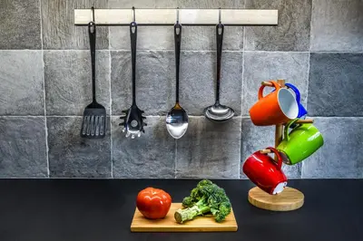 a kitchen counter with a cutting board with vegetables and utensils at Vintage City Apartments in Chania Town