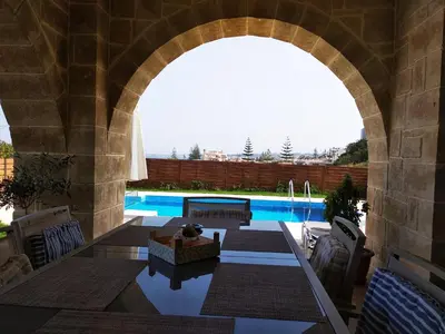 an archway over a swimming pool in a house at Villa Katerina in Agia Marina Nea Kydonias