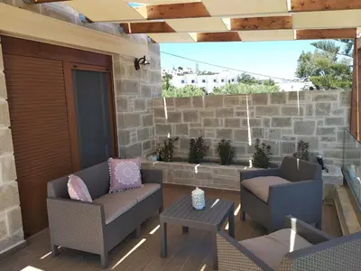 a patio with two chairs and a table at Villa Katerina in Agia Marina Nea Kydonias