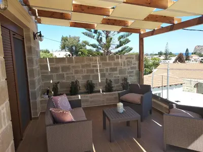 a patio with chairs and a table on a patio at Villa Katerina in Agia Marina Nea Kydonias