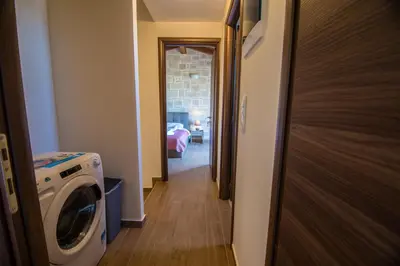 a hallway with a washing machine in a room at Villa Katerina in Agia Marina Nea Kydonias