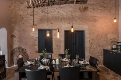 a dining room with a table and chairs at Boutique Villa Kalliope in Gavalochori