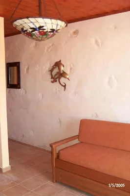 a monkey on the wall of a living room at Comfortable House near Chania in Kalathas