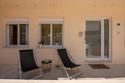 two chairs sitting in front of a house at Luxury Maisonette in Chania Town