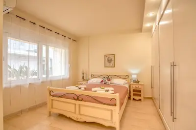 a bedroom with a bed and a window at Luxury Maisonette in Chania Town