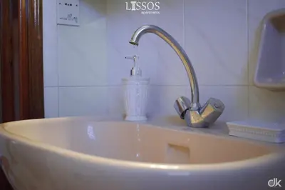 a sink with a faucet in a bathroom at Chania Lissosaparments in Kato Daratso