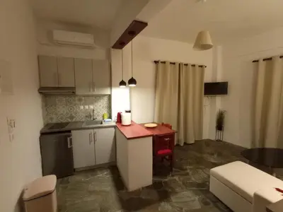 a small kitchen with a small table in a room at PALACE Sea view in Megála Khoráfia