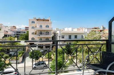a balcony with chairs and a view of a city at Aspasias Luxury Suite in Chania Town
