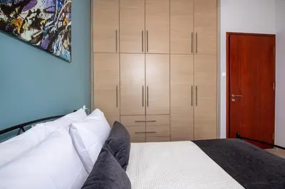 a bedroom with a bed and a wooden closet at Valia's House in Kato Daratso