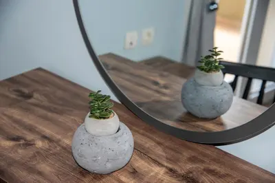 two vases with plants sitting on a table in front of a mirror at Valia's House in Kato Daratso