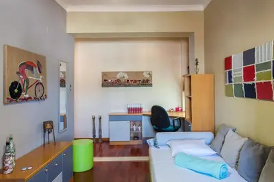 a living room with a couch and a desk at Sea view maisonette in Chania Town
